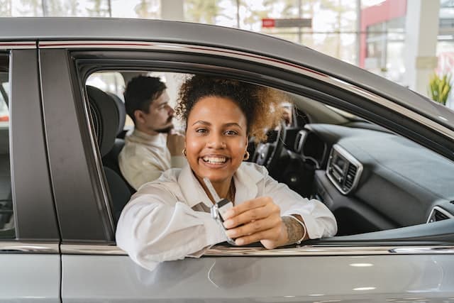 Woman in car holding keys